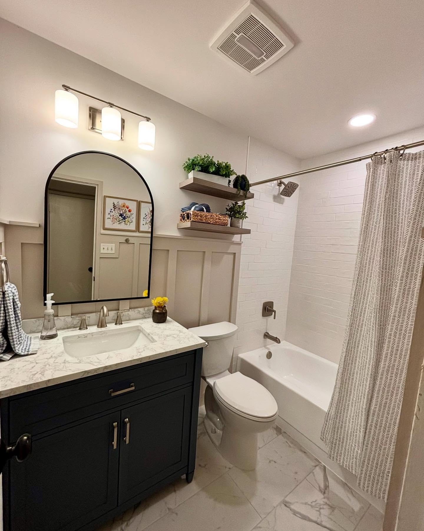 Full bathroom remodel with marble tile floor and subway shower tile
