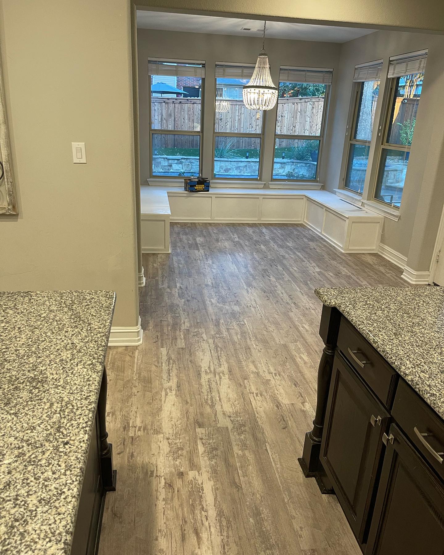 Custom curved staircase with stained hardwood treads and wrought iron balusters