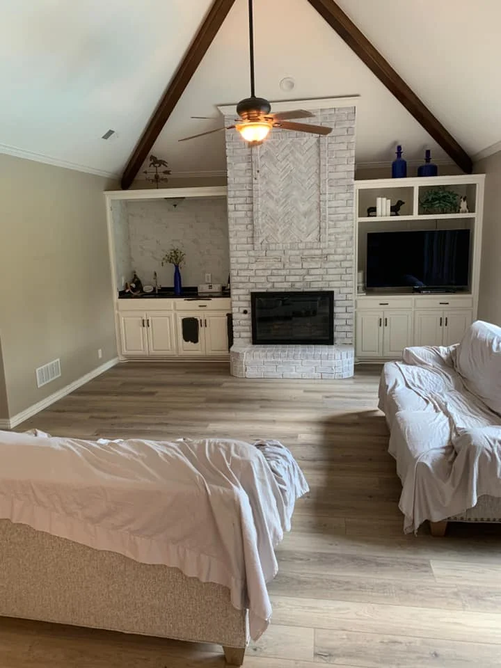 Modern kitchen with light wood-plank tile flooring and white cabinetry